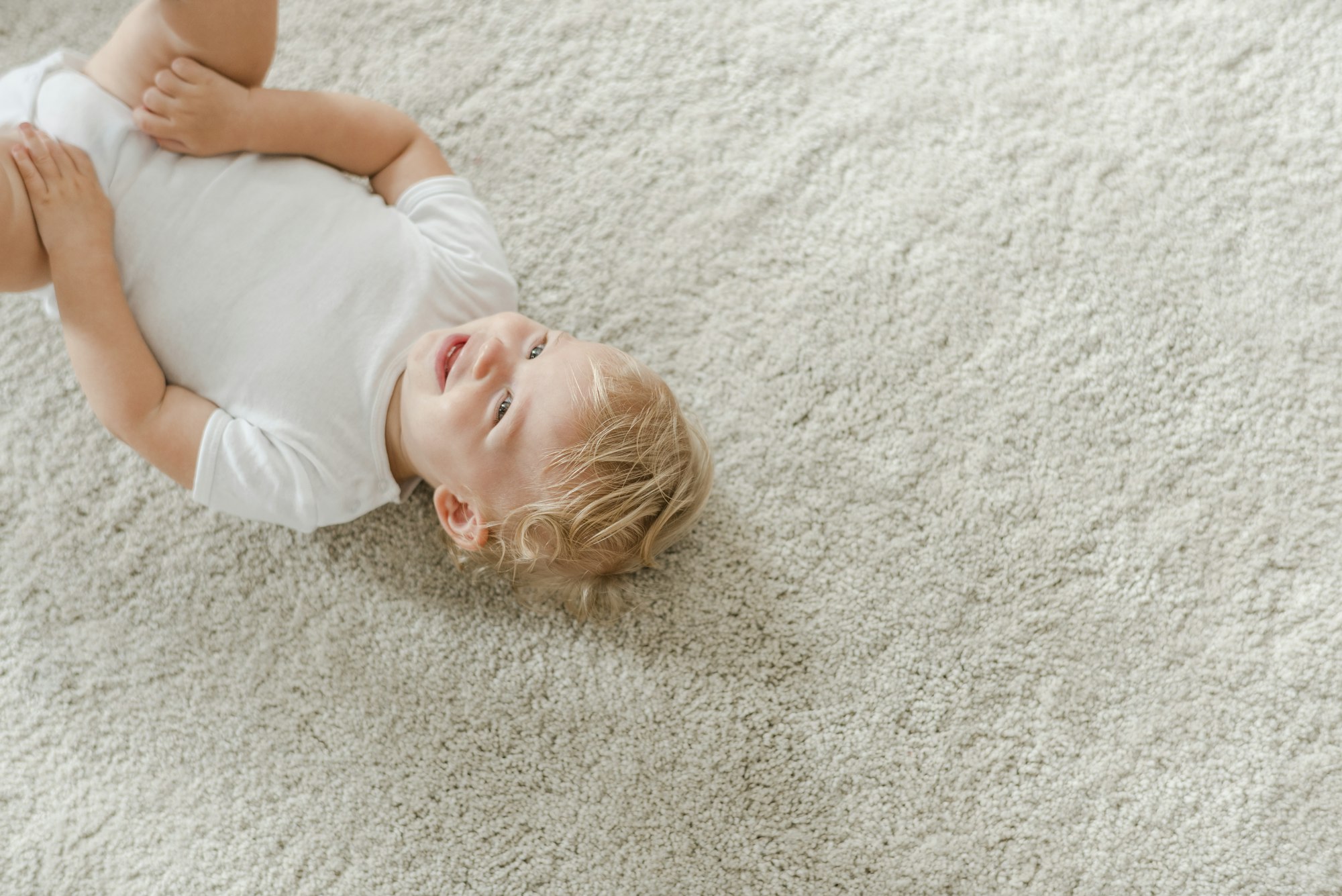 Cute baby lying on the carpet